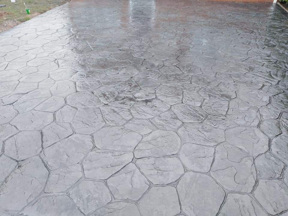 Random stone pattern imprinted concrete, freshly sealed