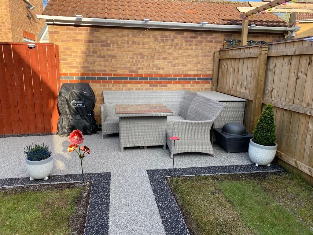 Resin bound patio and path with a contrast border in a rear garden